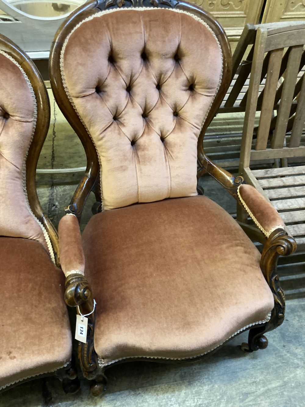 A pair of Victorian walnut spoon back button back chairs (one with arms)